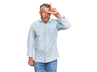 Sticker - Middle age grey-haired man wearing casual clothes making fun of people with fingers on forehead doing loser gesture mocking and insulting.