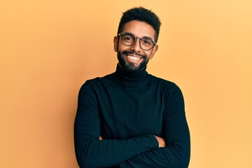 Wall Mural - Handsome hispanic man with beard wearing turtleneck sweater happy face smiling with crossed arms looking at the camera. positive person.