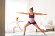 © Pixel-Shot - Young pregnant woman with her daughter practicing yoga at home