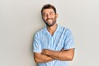 © Krakenimages.com - Handsome man with beard wearing casual shirt happy face smiling with crossed arms looking at the camera. positive person.