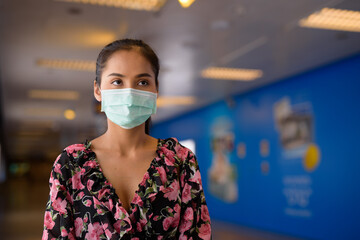 Wall Mural - Portrait of woman wearing face mask for protection against coronavirus Covid-19