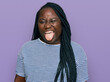 © Krakenimages.com - Young black woman with braids wearing casual clothes sticking tongue out happy with funny expression. emotion concept.