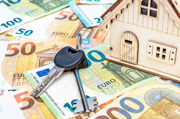 Wall Mural - Model of house with keys on euro bills. Close up.