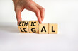 Ethical or legal symbol. Businessman turns wooden cubes and changes the word 'legal' to 'ethical' on a beautiful white table, white background. Business and ethical or legal concept. Copy space.
