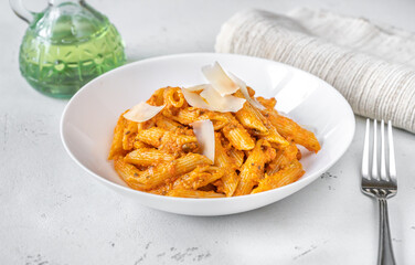 Wall Mural - Portion of penne pasta with orange pesto sauce