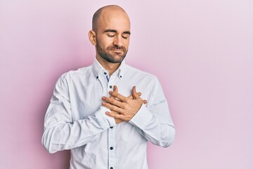 Canvas Print - Young hispanic man wearing casual clothes smiling with hands on chest with closed eyes and grateful gesture on face. health concept.