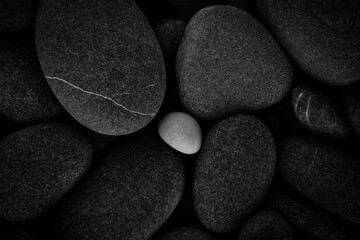 Wall Mural - Dark black abstract smooth round pebbles texture background