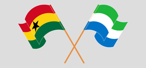 Crossed and waving flags of Ghana and Sierra Leone