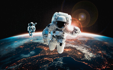 Astronaut spaceman do spacewalk while working for space station in outer space . Astronaut wear full spacesuit for space operation . Elements of this image furnished by NASA space astronaut photos.