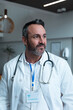 © wavebreak3 - Portrait of caucasian male doctor with stethoscope wearing lab coat in hospital