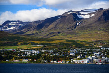 View Of Akureyri, The Country's Second Largest City, Dwarfed By Mountains Across The Eyjafjörður Fjord, North Iceland