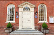 Easton ,MD, USA 04-16-2021: historic Courthouse building is among the oldest landmarks in the beautiful small town of Easton. Brick building has Talbot County Seals on both side of the entrance door.