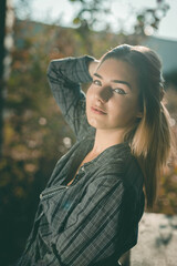 Sticker - Beautiful blonde Caucasian woman wearing flannel posing in an abandoned building