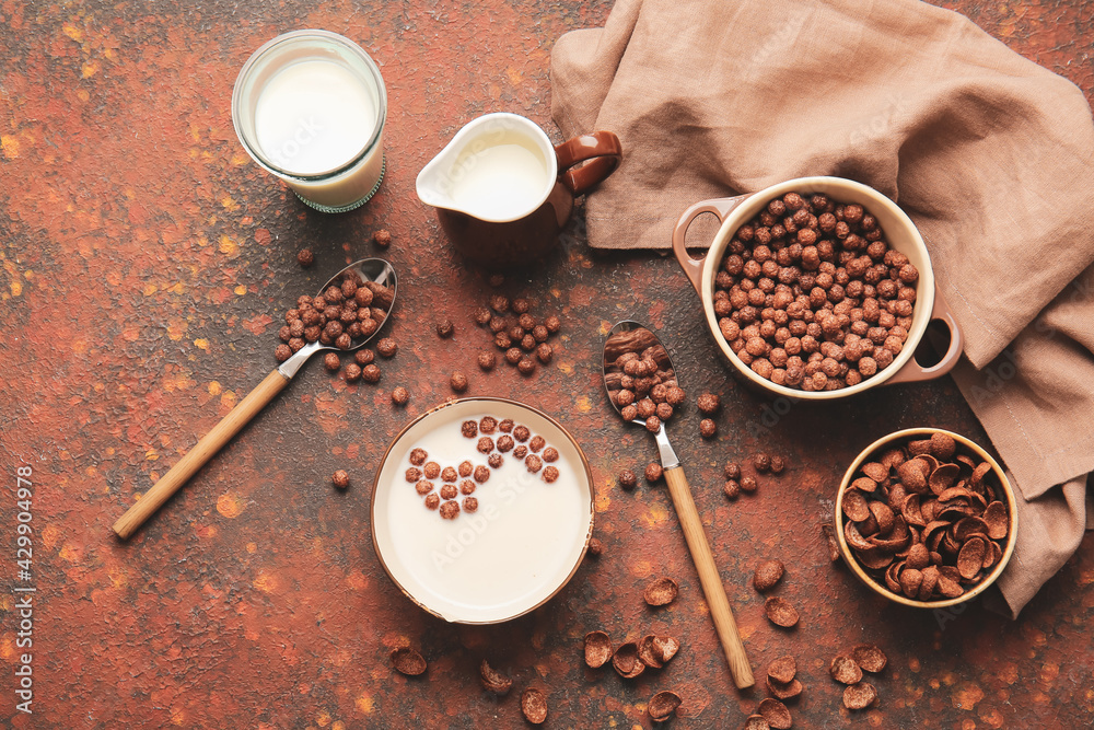 Bowls with chocolate corn balls on grunge background