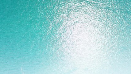 Wall Mural - Aerial view never endless sea surface view, Tropical beach water background. Soft wave of emerald clear sea