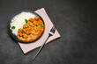 Plate of Traditional Chicken Curry and rice on dark concrete background