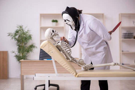 Devil doctor examining skeleton patient