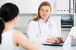 © JackF - Young woman having consultation with female doctor in hospital