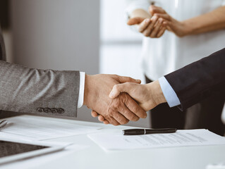 Business people shaking hands finishing contract signing, close-up. Business communication concept. Handshake and marketing