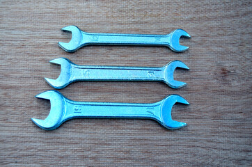 Wrenches on a wooden board.Locksmith tool.