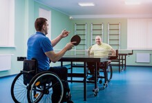 Adult Disabled Men In A Wheelchair Playing Table Tennis