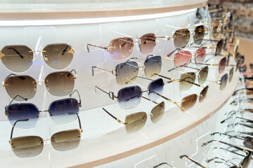 Sunglasses in the shop display shelves.