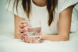 © Marina - teenage girl with a glass of water on the bed
