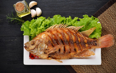 Fried Tilapia fish fried isolated on black background