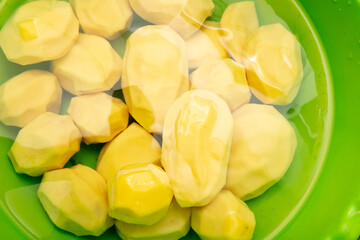 Sticker - Peeled potatoes in water as a background.