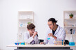 © Elnur - Young father and son chemists in the lab