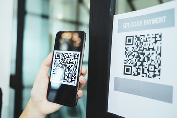 Online money, Close up hand holding smart phone for scanning Qr code for digital payment..