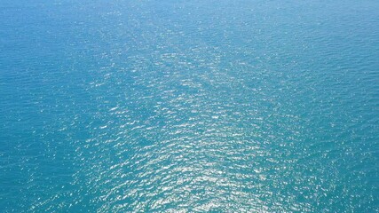 Wall Mural - Aerial view never endless sea surface view, Tropical beach water background. Soft wave of emerald clear sea