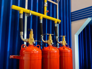 Fire extinguishing system cylinders on blue background. Industrial fire extinguishing system. Concept installation flame extinguishing systems. Fire safety at enterprise. Safety and rescue systems