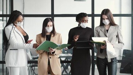 Wall Mural - Multi-ethnic business colleagues reviewing paper documents