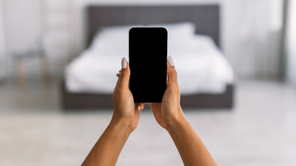 Pov of African American woman holding smartphone with blank screen