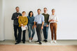 © Jacob Lund - Successful creative team standing against wall