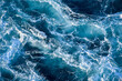 © DOF - Stormy ocean waves backlit by the light of the setting sun. Transparent. Navy blue. Blue. Background. Pattern.