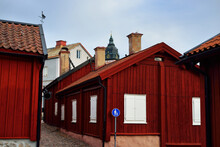 Traditional Swedish Houses Colored With Falu Red Dye. Tiled Roofs. Empty Street. Strängnäs, Mälaren Lake, Sweden. Travel Destinations, Landmarks, Sightseeing, Vacations, Recreation, Estate, Home