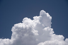 Cumulus Congestus Cloud. A Single White Clouds With Sharp Edges Under A Blue Sky