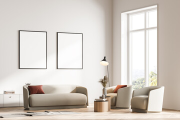 Modern living room interior with two armchairs, sofa and commode, lamp. Two mock up framed posters on white wall. Reading and relax concept. No people. 3d rendering.