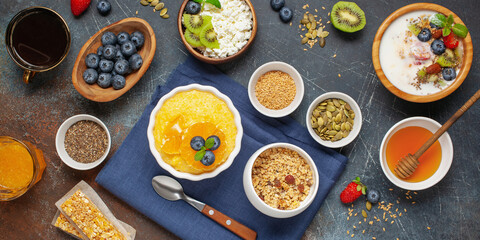 Wall Mural - Healthy breakfast set with corn porridge, yogurt, berries, coffee and granola. Top view. Flat lay