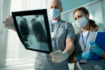Poster - Discussing lung x-ray image with assistant