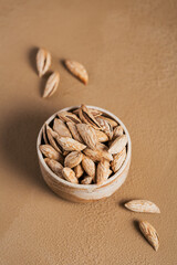 Wall Mural - Pile of Almond nuts in a bowl on a white background