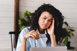 © InsideCreativeHouse - Extremely exhausted young african businesswoman suffering from headache at the workplace. Lazy apathetic black female university student frustrated about study computer work