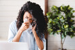 © InsideCreativeHouse - Sneezing sick with flu and cold young african businesswoman asking for sick leave on phone at work. Ill young black woman with cold, sitting at desk with laptop computer and sneezing for allergy.