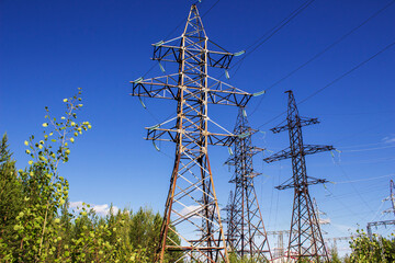 High-voltage power lines against a blue sky