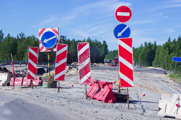 Broken road, roadbed repairs. There are forbidding signs and signs on the road