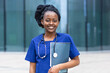 © Елена Якимова - smart black girl medical student, happy young african american woman doctor, nurse in blue uniform, stethoscope, smiling afro female at university, college, hospital, clinic. copy space
