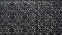 Traditional Islamic Rhythmic Arabesque Pattern In Form Of Embossing On Metal. Textured Black Silver Metal Backdrop With Intricate Carved Interlace Foliage And Flowers Elements, Decoration Chasing Art.