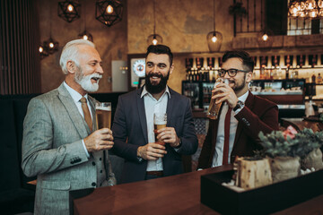  Three business people celebrating successfully done job at restaurant.